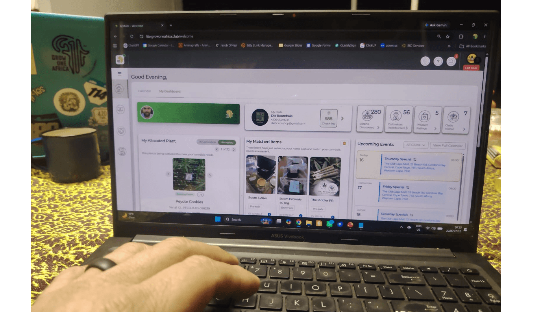 GOAlite Cannabis Management Software on laptop showing Member Dashboard with membership status, club details, plant reporting photos, available products and calendar events